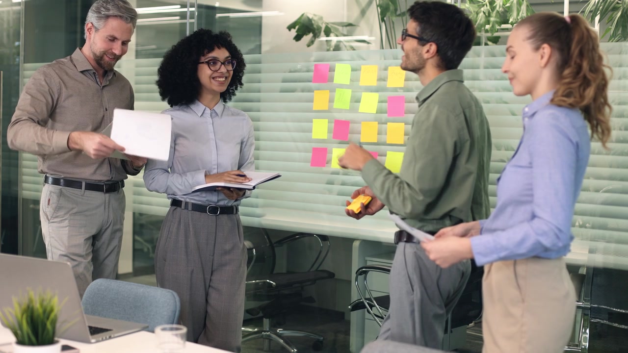 Diverse Business Team Brainstorming Ideas on Glass Board in Modern Office