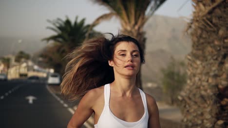 Long-Haired-Road-Runner-Woman-Running-,-Jogging-Along-The-Palm-Grove-In-White-Sport-Clothes