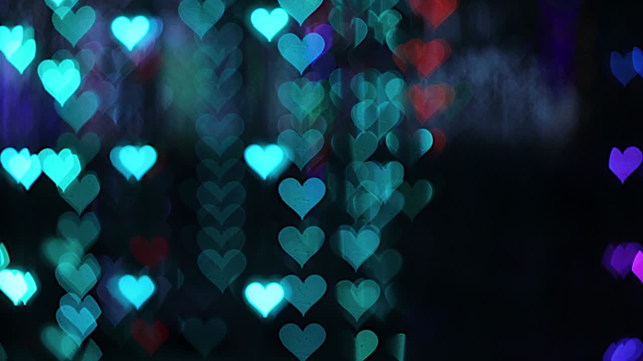 4k uhd video de fondo para el día de san valentín. frontera con bokeh de corazones románticos brillantes y relucientes en un fondo negro. amor, bokeh en forma de corazón.