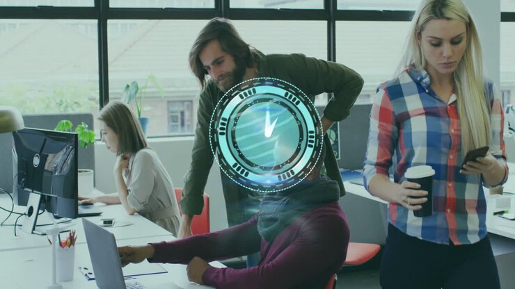 Diverse office team working on laptops with digital data animation overlay