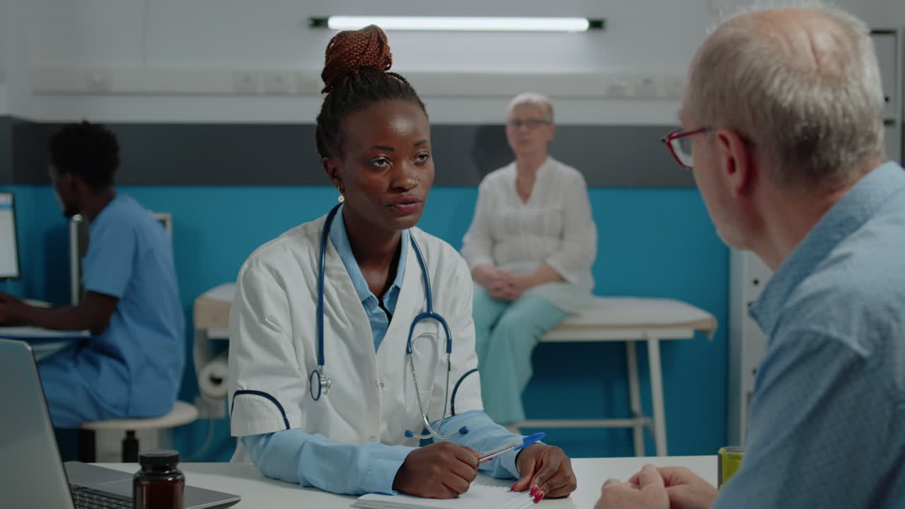 Doctor discussing with senior ill patient in healthcare office