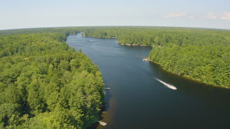 aerial view flying over a jet ski on a beautiful river on a summer day