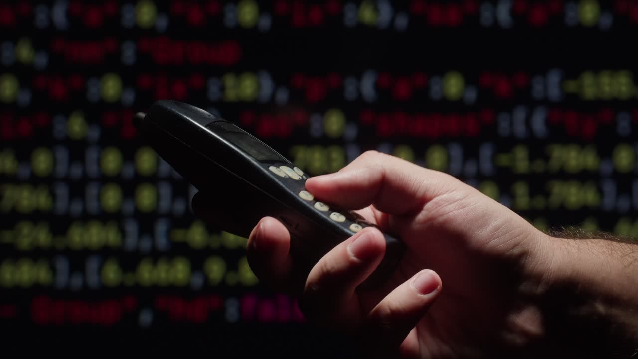 Hand holding a vintage cell phone