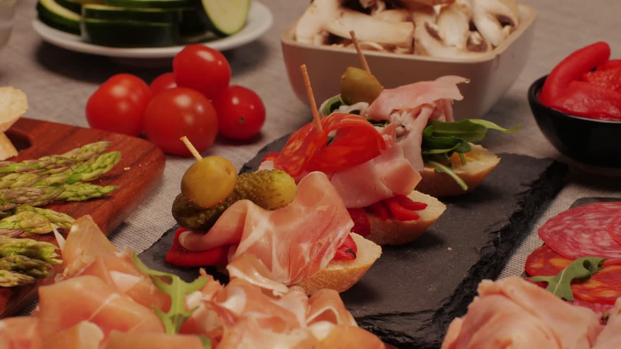 Italian or Spanish restaurant with traditional tapas food, Spanish cuisine, delicious tapas and cheese plate, bruschetta with cheese, olives dry tomatoes and tasty sandwich bar appetizer, buffet