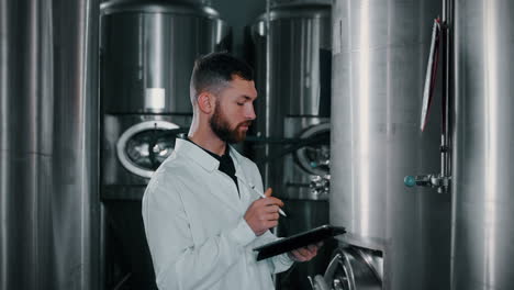 brewery worker inspecting tanks