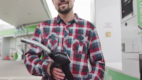man filling up at a gas station