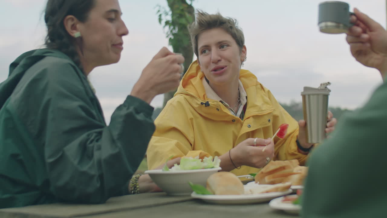 Friends Toasting with Tea on Picnic at Campsite