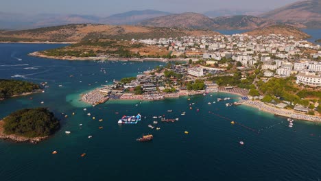 ksamil, albania, with boats and tourists enjoying the crystal clear turquoise waters, aerial view