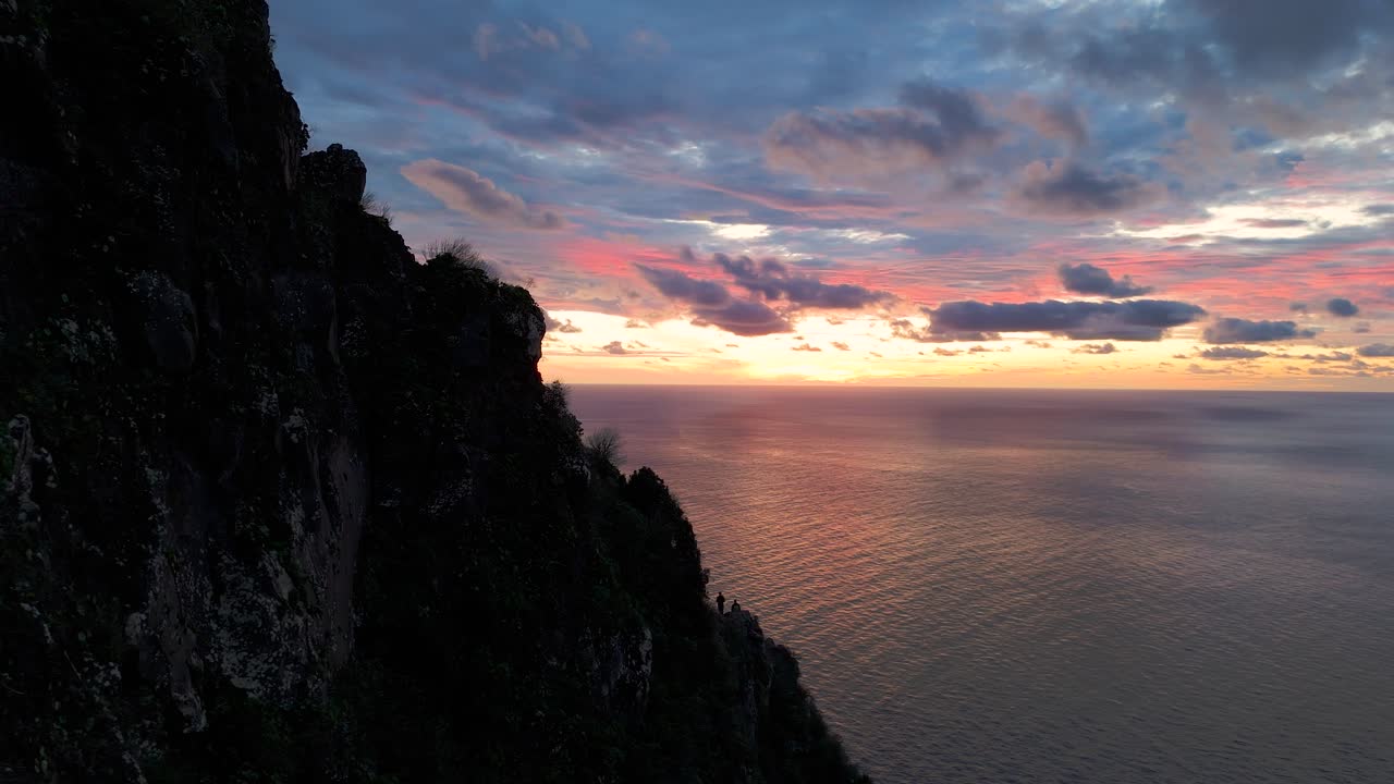 Drone reveal of Ponta da Ladeira cliffs of Madeira, charming coastline stretching into the horizon with magical dusk hues
