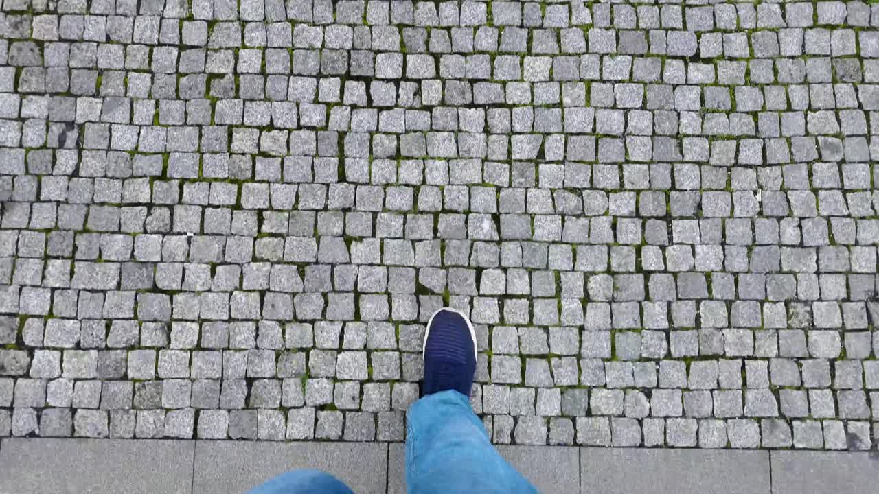First Person View of Person Walking on Cobblestone Pavement