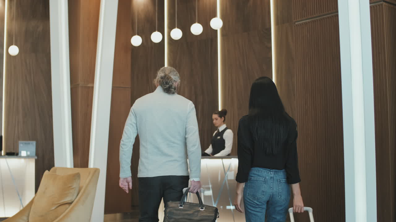 Couple Checking-In at Hotel