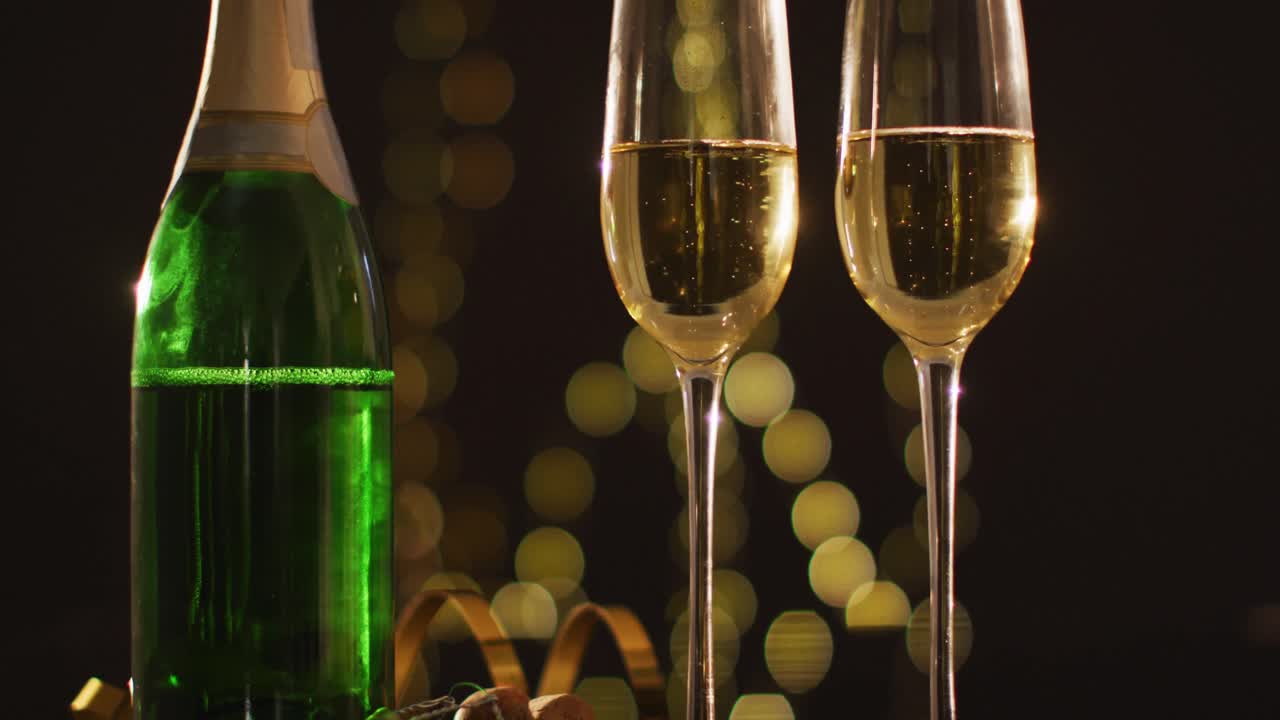 Champagne glasses and decorations on black background at new year's eve