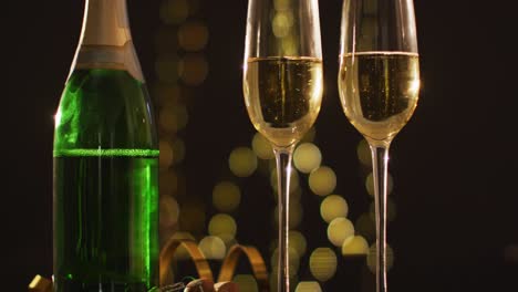 Champagne glasses and decorations on black background at new year&#039;s eve