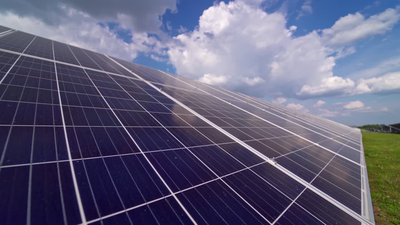 Blue solar panel close-up. Alternative source of electricity on solar energy farm. Source of ecological renewable energy. Motion camera back.