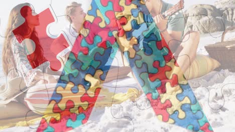 Animation-of-colourful-puzzle-pieces-ribbon-over-happy-friends-at-summer-beach-party