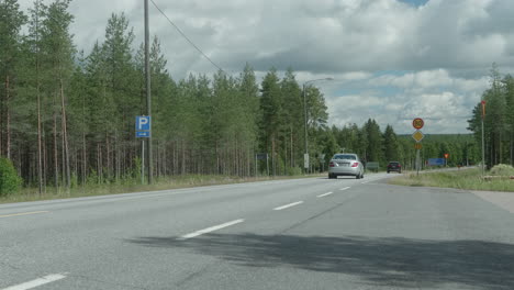 traffic on the countryside in finland, near kyyjärvi, sunny day, cars passing by