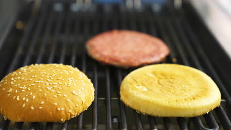 chef cooking meat burger. chef prepares fast food at the restaurant