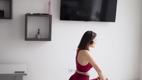 woman putting on music in headphones and starting stretching legs