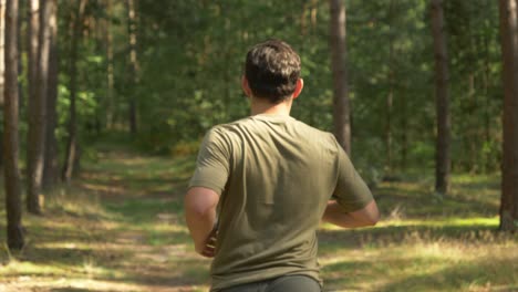 Young-Man-In-A-Healthy-Lifestyle-While-Jogging-Along-The-Country-Road-At-Norwegian-Village-In-Arendel,-Zagorow-Poland