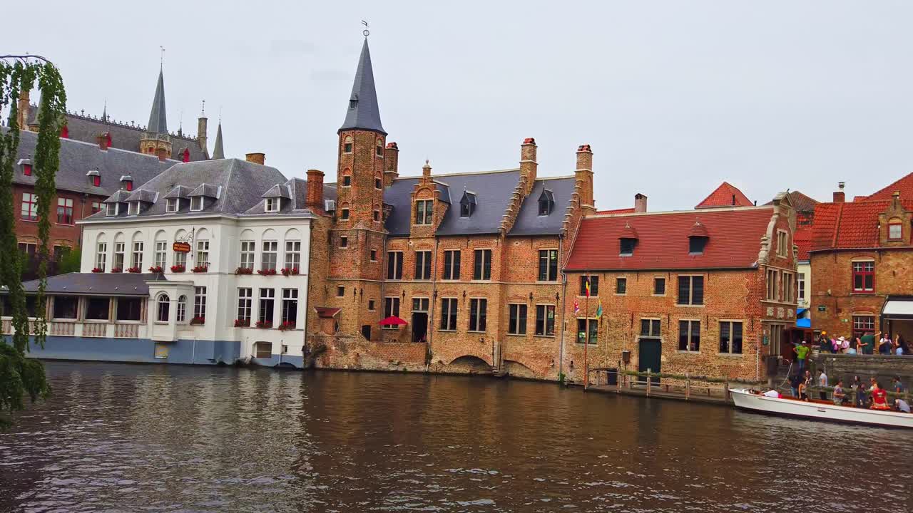 BRUGGE, BELGIUM - JUNE 26, 2019: Panorama view of old buildings and Leie river