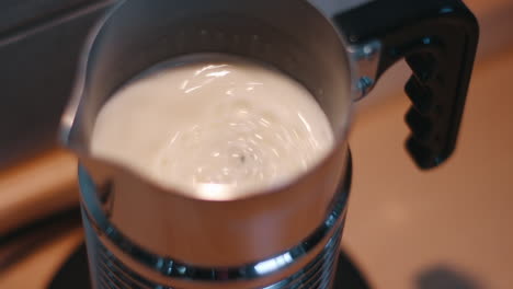 Milk-foamer-frothing-milk-in-slow-motion