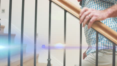 Animation-of-light-moving-over-midsection-of-senior-caucasian-man-with-cane-climbing-staircase