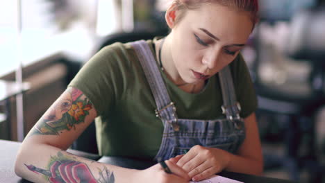 woman tattoo artist working on a design