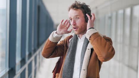 stylish young man listening to music on headphones