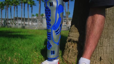 person with a prosthetic leg in a park