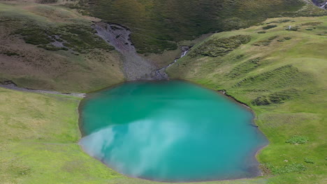 Drone-shot-of-people-in-Oreit-Lake-in-Tusheti,-Georgia,-in-the-Caucasus-mountains