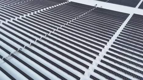 during the winter, a wisconsin field of solar panels absorbs the sun's energy and converts it to electricity.