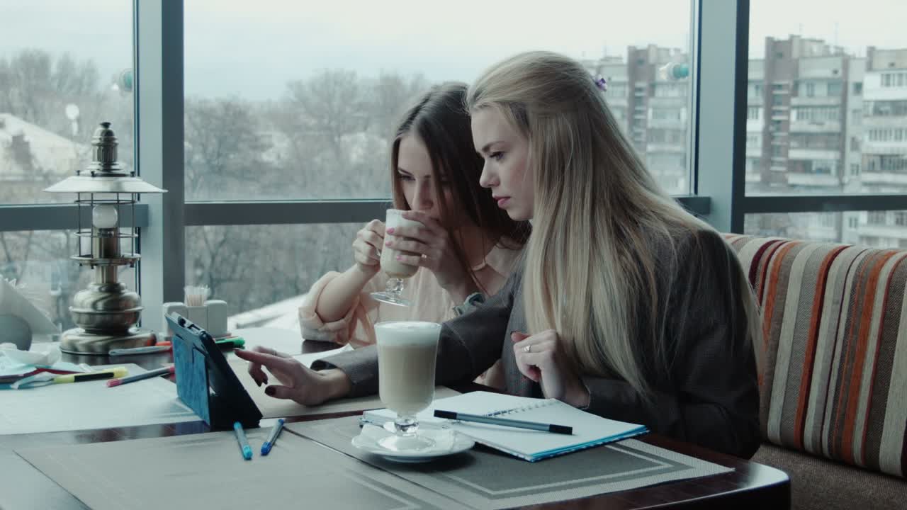 Two Girls Designers Discuss The Project Using Tablet