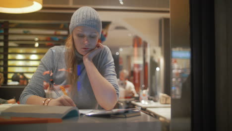 woman making notes in notebook