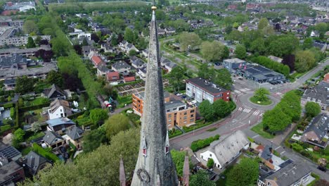 Traditional-Catholic-Church-spire-and-exterior-in-the-Netherlands,-aerial