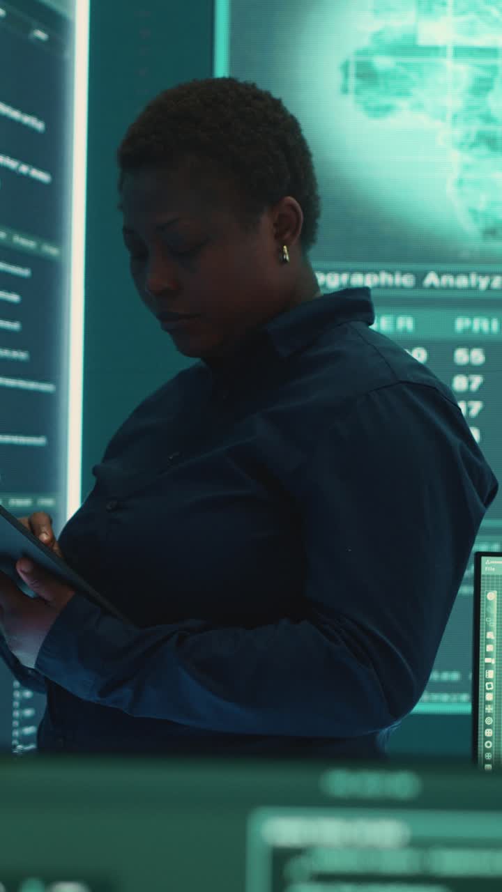 African American Woman Programmer Working on Tablet in Server Room