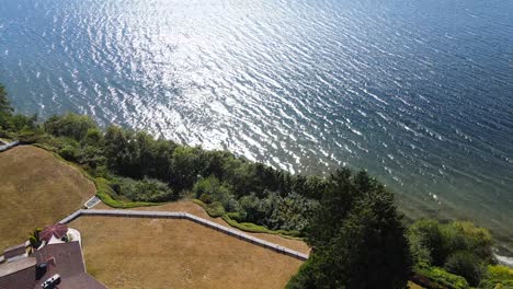 aerial drone showcases luxury homes on the pacific northwest coast in washington