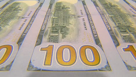 SHEET-OF-100-DOLLAR-BILLS-MOVING-TOWARDS-CAMERA