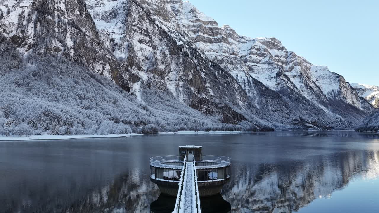 Snow covered lakeside platform on Klöntalersee in winter Switzerland