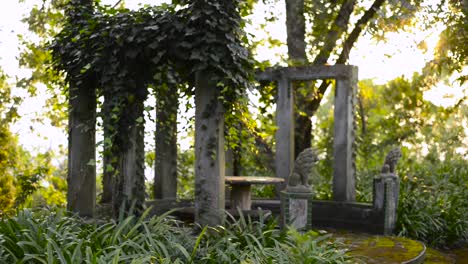 Pan-of-ruins-in-garden-at-sunset