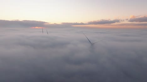 drone shot of a windturbine in foggy conditions