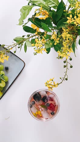 refreshing summer drink with berries and flowers