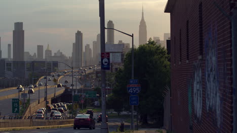empire state building and midtown manhattan nyc skyline with graffitied brick building in foreground