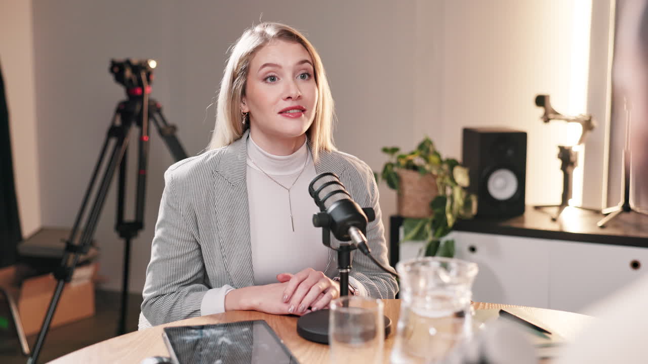Woman recording a podcast interview in a studio