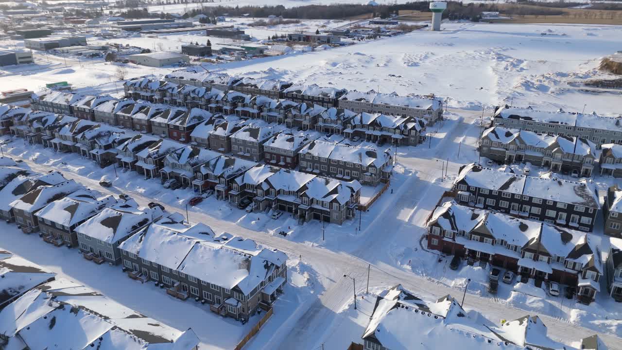 Drone footage of a newly built housing development in Erin, Ontario. Snow covered streets and modern homes illustrate residential expansion and new construction during a period of housing demand