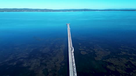 drone aerial landscape of long jetty wooden boardwalk pier wharf waterfront in tuggerah lake water catchment the entrance suburban town central coast australia travel tourism coastline