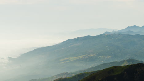 coastal mountain range over looking ocean with clouds sea breeze fog time lapse