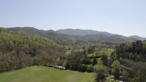 aerial over field in smokey mountains