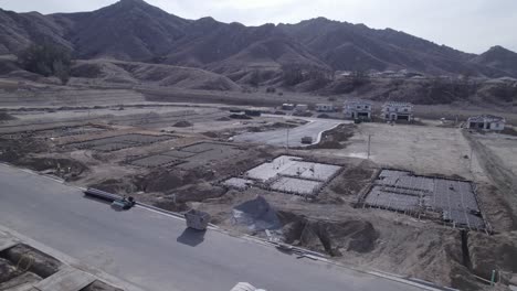 a slow-moving drone shot offers a comprehensive view of a developing new neighborhood, highlighting multiple foundations being laid throughout the video