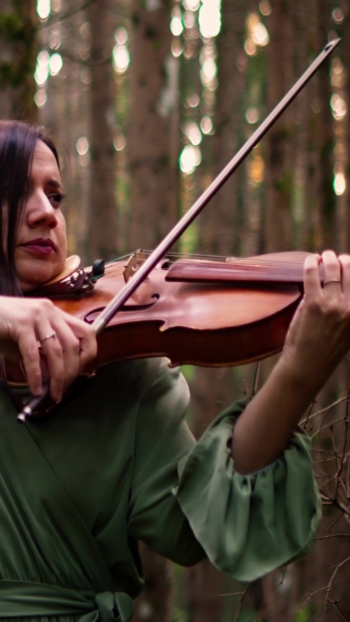 Woman Playing Violin in a Forest Setting