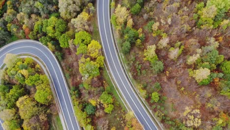 Curves-on-serpentine-thoroughfare-road,-passage-in-mountain-forest,-flyover